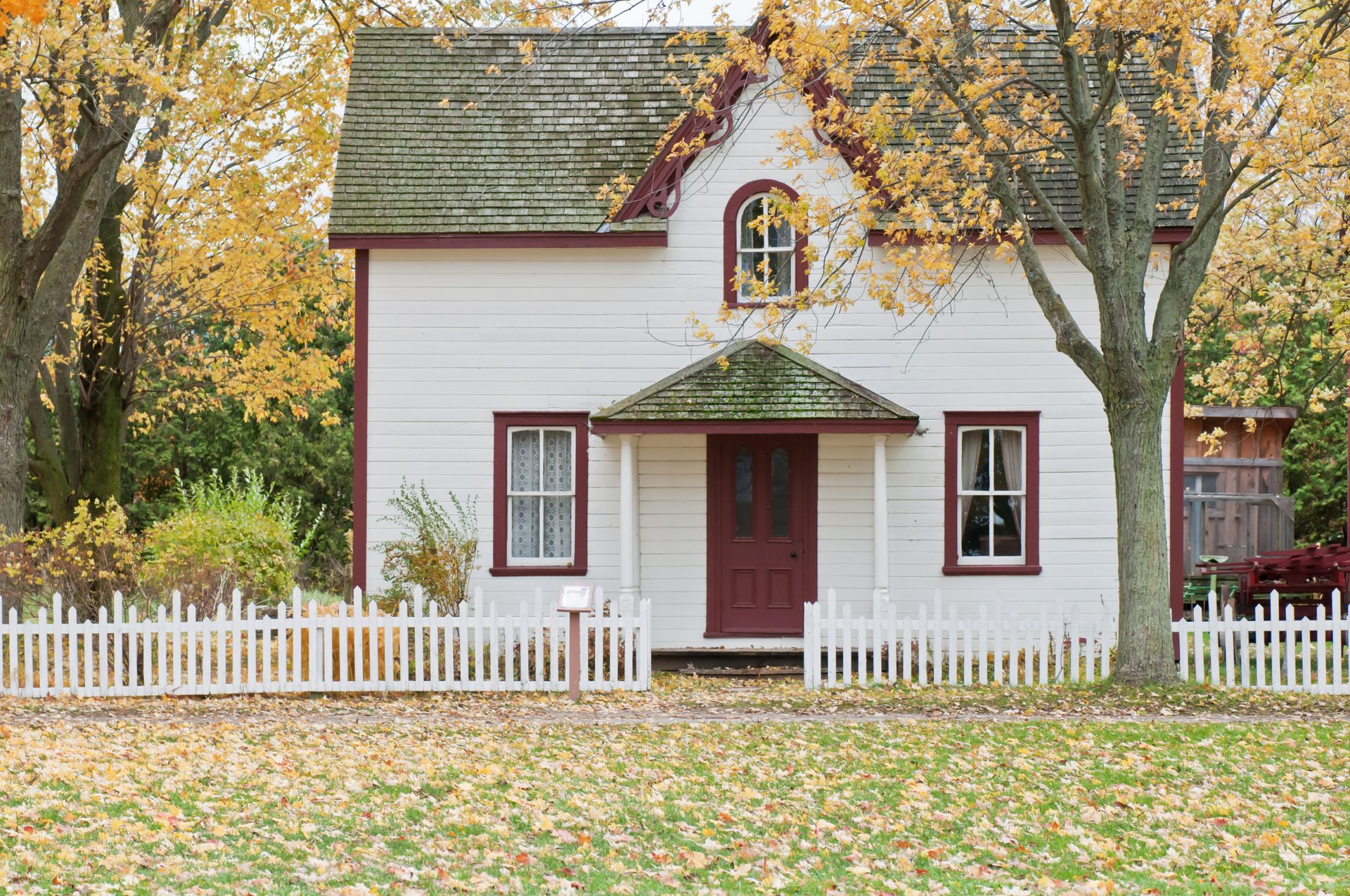 Residential house with white wooden fence