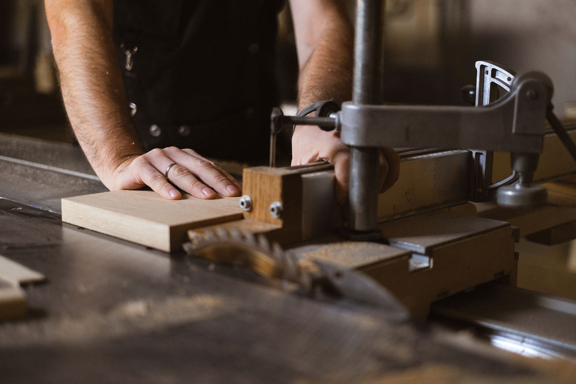 Craftsman working with a table saw in a woodworking workshop