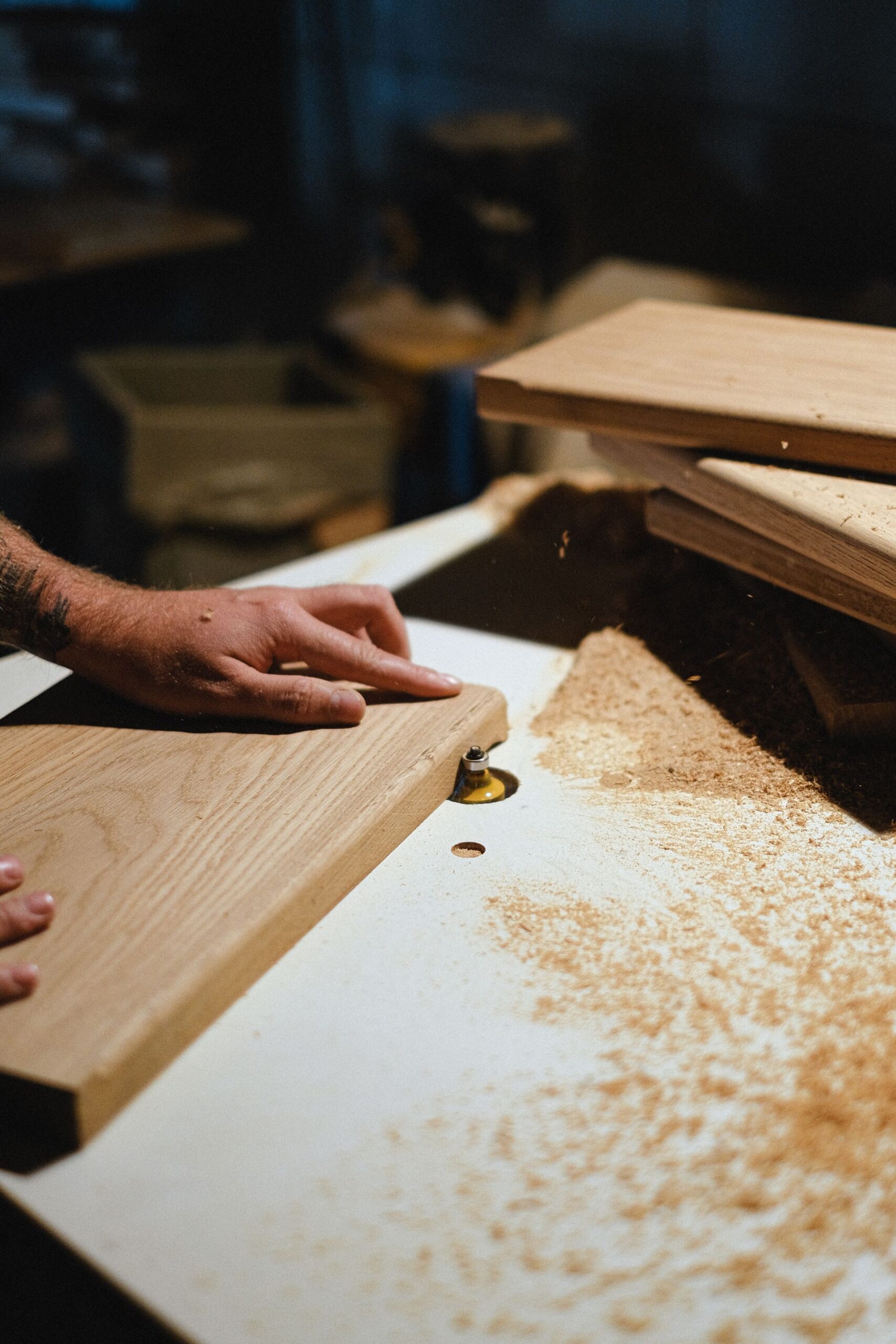 Craftsman shaping a wood plank in a workshop