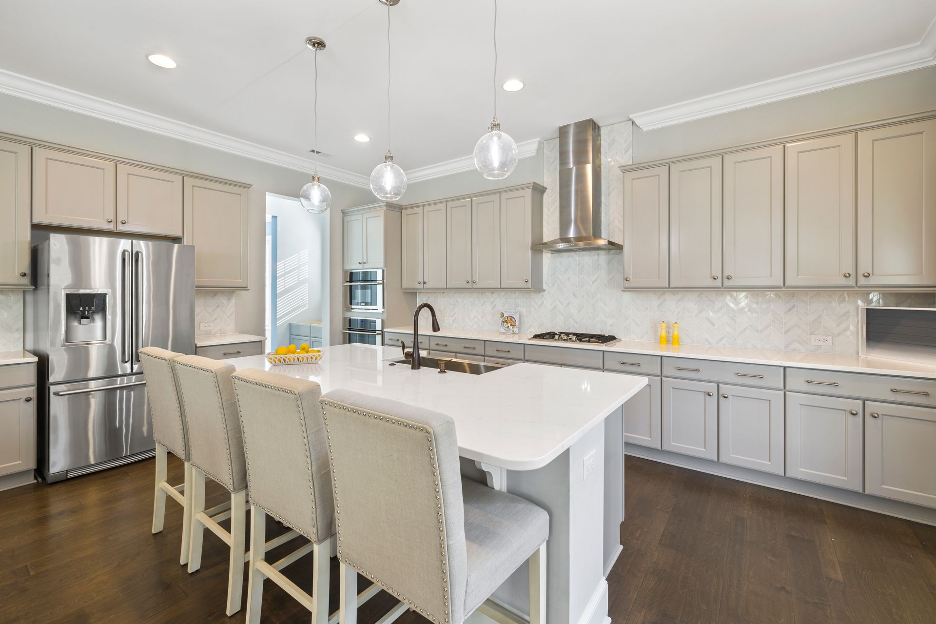 Modern kitchen with white cabinets and stainless steel appliances